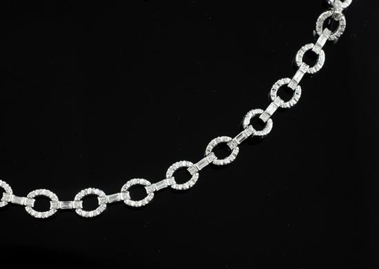 A modern 18ct white gold and round and baguette cut diamond set open work bracelet, approx. 18cm.